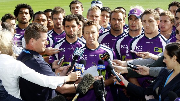 Surrounded by all 22 players,  Craig Bellamy reads a statement to the media in April 2010  regarding the future of the club in light of the penalties handed out by the NRL.