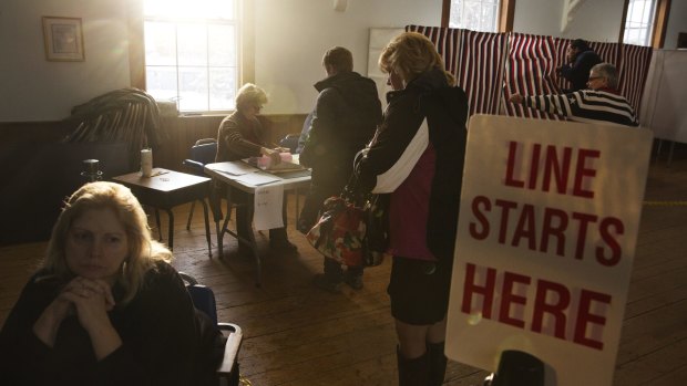 Voters arrive to cast their ballots in the first-in-the-nation New Hampshire presidential primary at the Chichester Town Hall in Chichester, New Hampshire.