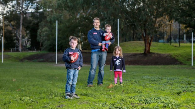 Peter Behrendorff with his kids Harvey 6, James 2 and Elva 4, has welcomed new guidelines for children playing sport with suspected head injuries.