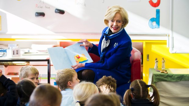 Dame Quentin reads to kindergarten students in 2013. 
