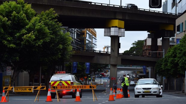 Police closed Sussex and Hickson streets as experts worked to find a way to lower the damaged crane at Barangaroo.