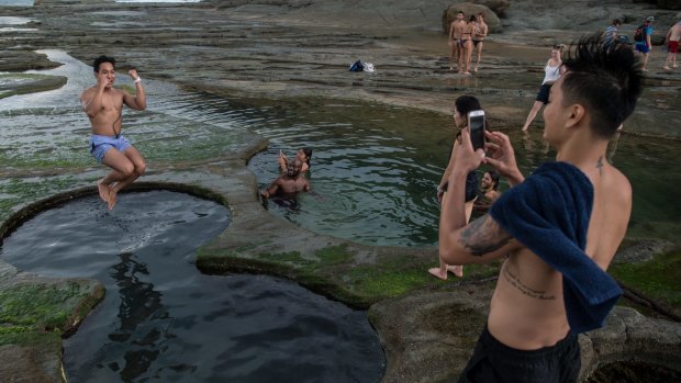 Tourists pose for photographs earlier in January at the Figure Eight Pools in the Royal National Park.