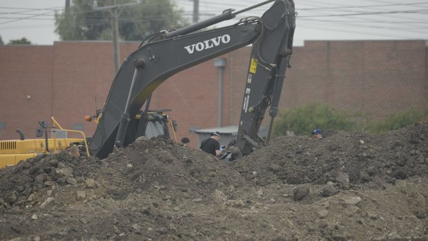 The 30-tonne excavator used in the initial dig now replaced by hand searches