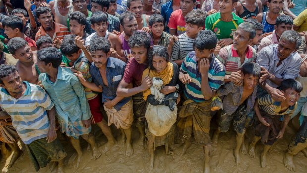 Rohingya Muslims, who crossed over from Myanmar into Bangladesh, wait to receive handouts near Balukhali refugee camp, Bangladesh.