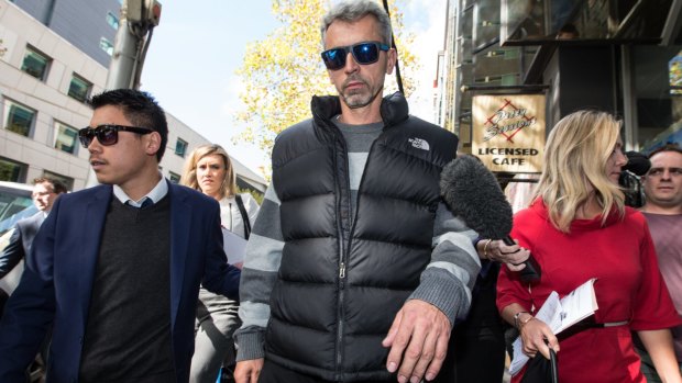 Vehid Causevic (centre), the father of Harun Causevic, leaves court.