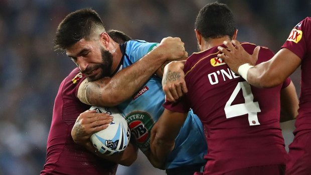 On the charge: James Tamou takes on the Maroons in game one.