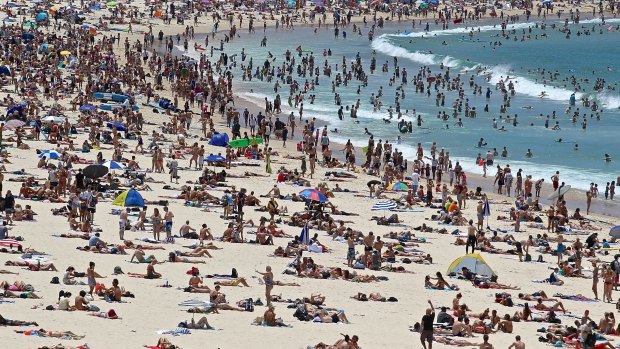 Sunny change: Hot holiday weather brought the masses to Bondi Beach on Monday.