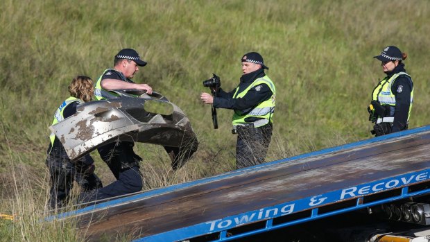 Police photograph the second car involved in the fatal crash in Barnawartha North. 
