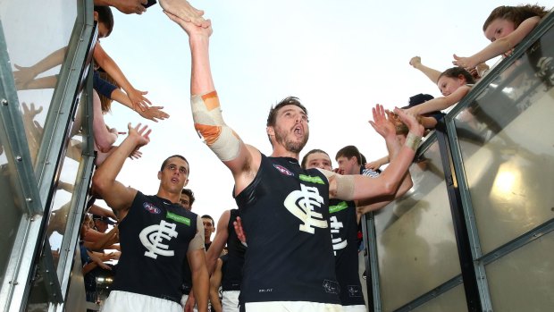 Dale Thomas celebrates with supporters after Carlton's win over Collingwood.