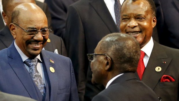 President of the Congo Republic Denis Sassou Nguesso (right) looks on as Sudanese President Omar al-Bashir is greeted by Zimabwean President Robert Mugabe at the African Union summit in Johannesburg.