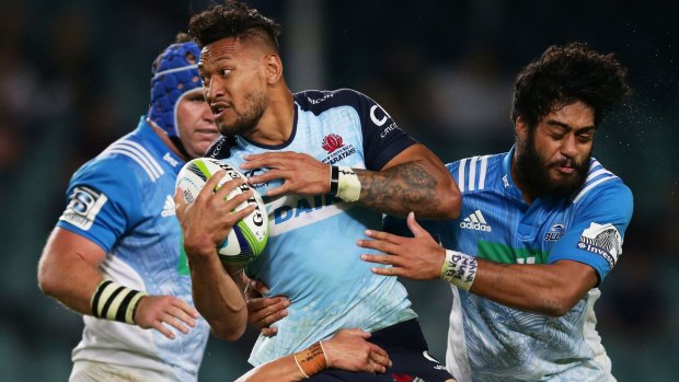 Israel Folau of the Waratahs is tackled during the Super Rugby match between the Waratahs and the Blues in Sydney.