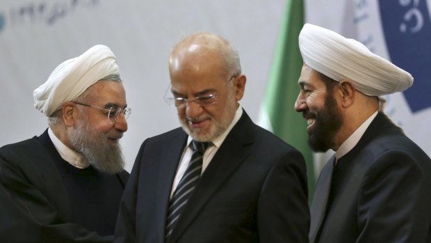 Iranian President Hassan Rouhani, left, with Syrian Grand Mufti Ahmad Badreddine Hassoun, right, and Iraqi Foreign Minister Ibrahim al-Jaafari (centre) at the 29th International Islamic Unity Conference in Tehran, Iran on Sunday.