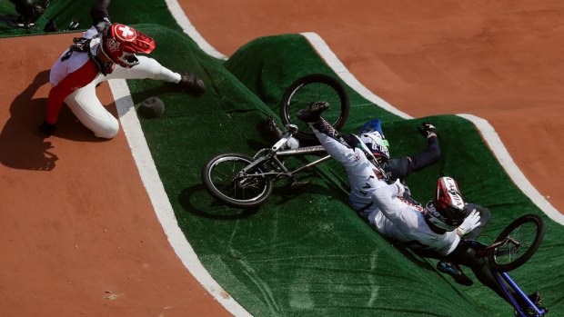 David Graf of Switzerland, left, and Maris Strombergs of Latvia, right, fall during the BMX cycling quarter-finals .