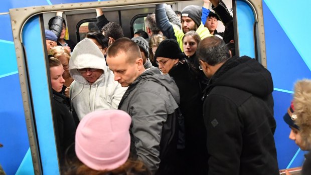 Passengers try to squeeze aboard a packed train duringr the rail meltdown.