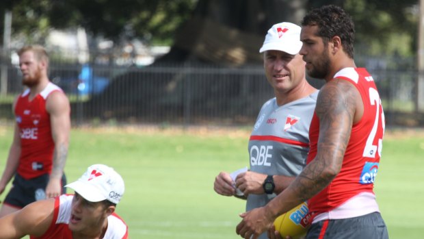Private matters: Swans coach John Longmire chats with his superstar forward Buddy Franklin. 