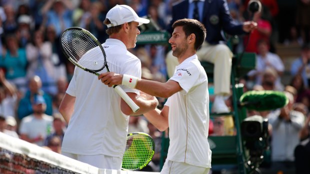 Querrey shakes hands with Djokovic following his victory.