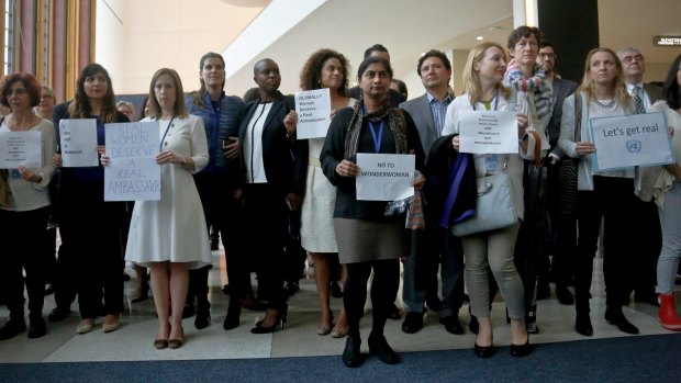 UN staff stand in a silent protest against Wonder Woman's appointment.