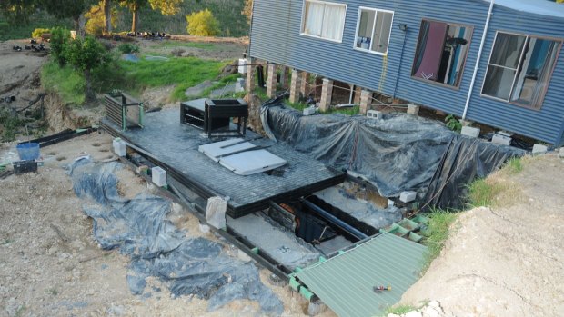 A trapdoor led to three buried shipping containers where a large hydroponic cannabis set up was allegedly discovered.