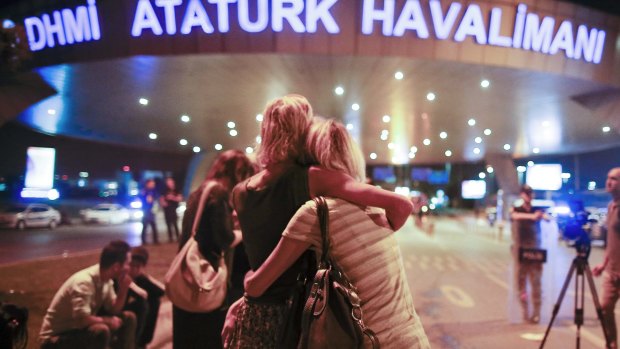Passengers embrace each other at the entrance to Istanbul's Ataturk airport, early Wednesday, June 29, 2016 following their evacuation after a blast. Suspected Islamic State group extremists have hit the international terminal of Istanbul's Ataturk airport, killing dozens of people and wounding many others, Turkish officials said Tuesday. Turkish authorities have banned distribution of images relating to the Ataturk airport attack within Turkey. (AP Photo/Emrah Gurel) TURKEY OUT