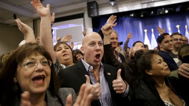 Angry voters align with Trump camp: Supporters cheer during a caucus night rally for Donald Trump.