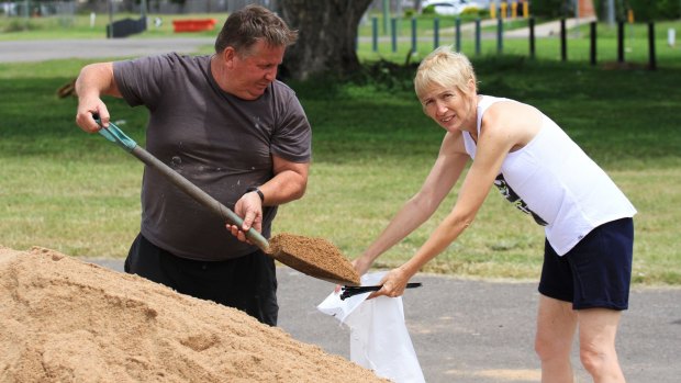 Karen and David Baldwin fill sandbags for their home and their kids'.