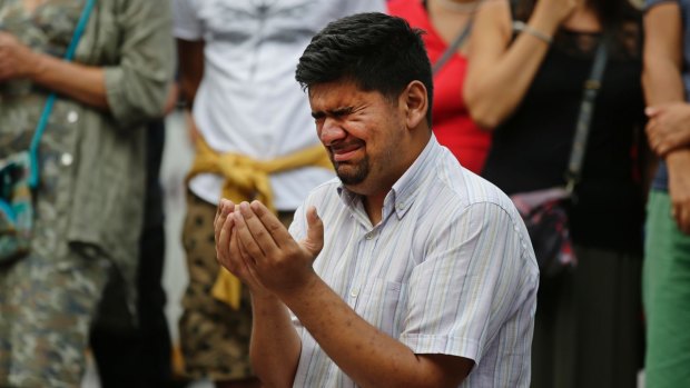 A man cries as he prays by a memorial  to  victims of this month's Barcelona attack.