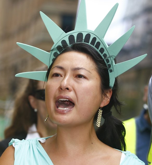 A woman dressed as the Statue of Liberty protests against US President Donald Trump's travel ban in Sydney.