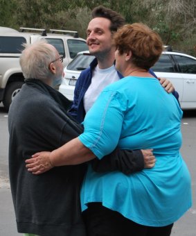 Alan Baxter-Piggford, Toby Melville-Brown and Penny Melville Brown embrace after the ordeal.