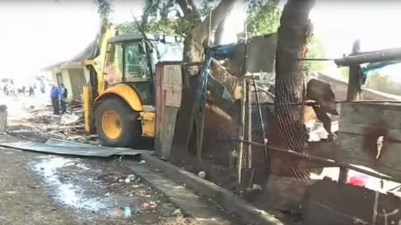 Bulldozers demolishing the shanty town at Paga Hill, Port Moresby.