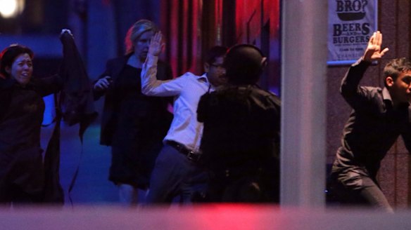 Hostages flee after police raided the Lindt cafe.