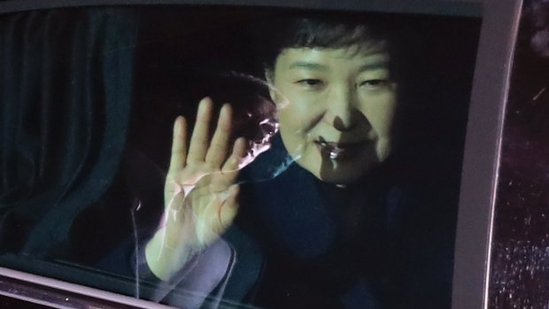 President Park Geun-hye waves to her supporters from her vehicle upon her arrival at her private home in Seoul.