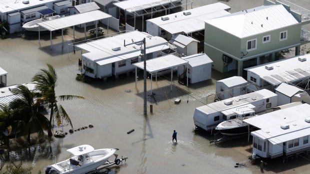 A person walks through the flooded streets of a trailer park in the aftermath of Hurricane Irma.
