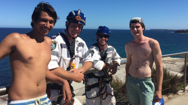 James Laybutt,17, left, and Ben Standfort, 18, with their police rescuers.