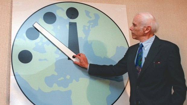 Leonard Rieser, chairman of the Board of the Bulletin of the Atomic Scientists and a member of the Manhattan Project, moves the minute hand to 11:51pm in 1998.