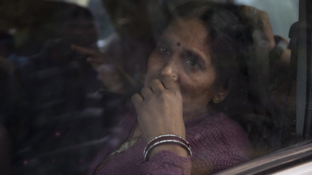 The mother of the victim of the fatal 2012 gang rape arrives to join protesters in New Delhi on Sunday.
