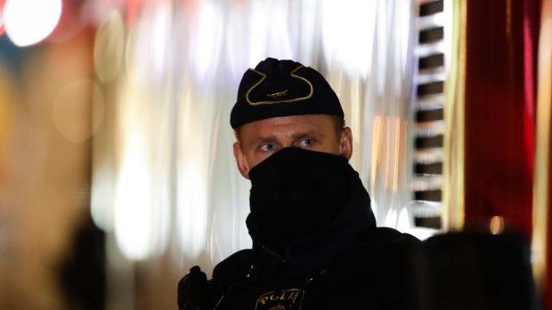 A police officer guards the scene after a truck was driven into a department store in Stockholm.