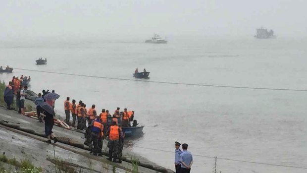 Rescue workers search after a ship carrying 458 people sank in the Yangtze River.