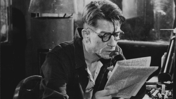 Winston (actor John Hurt) at work in the Ministry of Truth where he re-writes history. From the British film "1984" (1984).