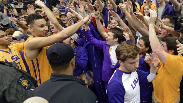 Future NBA superstar? Simmons, second from left, celebrates with fans after a Louisiana State University win.