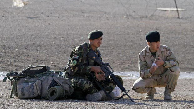Afghan National Army soldiers wait at a military airport in Uruzgan province, Afghanistan, on Tuesday. 