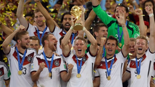 Germany's Bastian Schweinsteiger holds up the World Cup trophy after victory in the 32-team tournament in 2014.