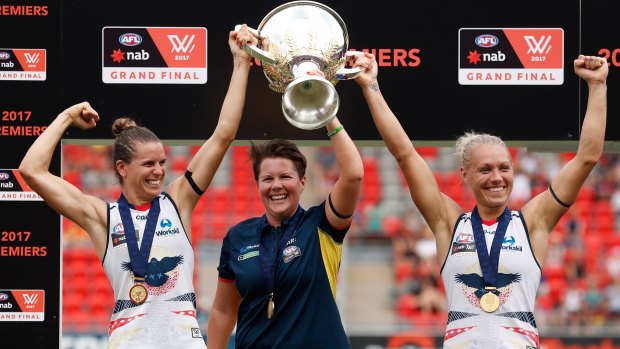 Chelsea Randall, Bec Goddard and Erin Phillip hold the cup aloft after the Crows won the inaugural AFLW premiership against the Lions.