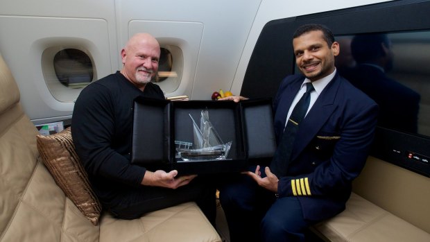 Gino Bertuccio, in the Residence living room, receives a commemorative crystal dow from Captain Ali Al Jabri, who took control of Etihad Airways inaugural A380 flight.