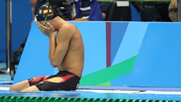 Spain's Miguel Duran Navia cries after tumbling into the pool before his heat. 