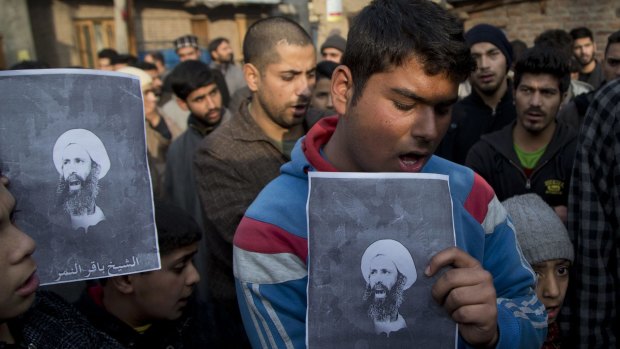 Kashmiri Shiite Muslims hold portraits of the executed cleric Sheikh Nimr al-Nimr during a protest.