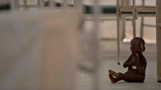 A young child sits on the floor in the therapeutic feeding unit of the Medecins Sans Frontieres in Bentiu, South Sudan