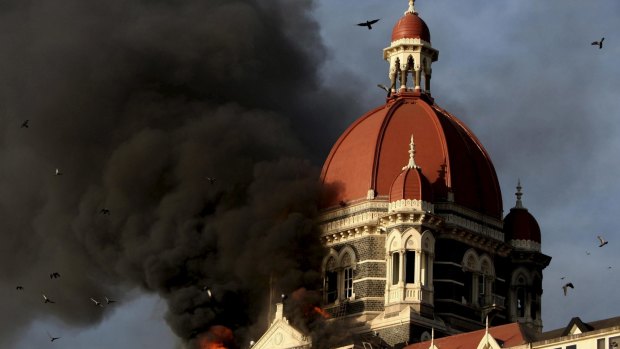 Flames and smoke gush from the historic Taj Mahal Hotel in Mumbai, attacked by terrorists in 2008.