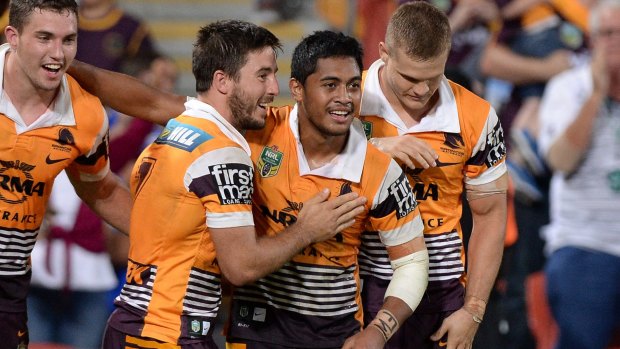 On form: Anthony Milford of the Broncos celebrates with team mates after scoring.