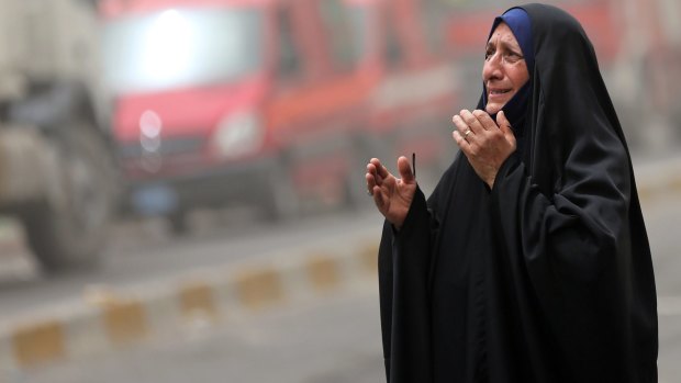 A woman grieves at the scene of a deadly suicide a car bomb in the Parada neighbourhood of Baghdad.