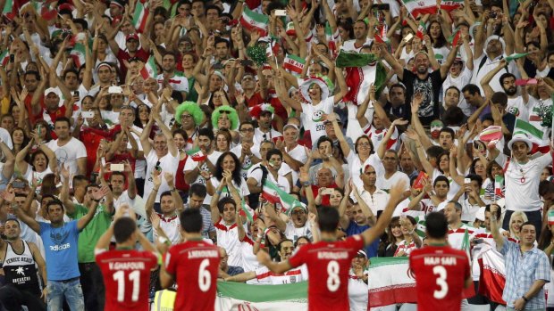 Fan club: Iran players celebrate victory over Qatar with their supporters